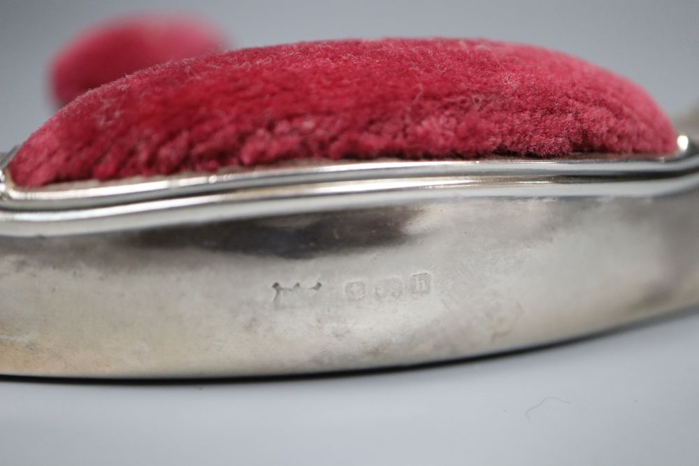 Two early 20th century novelty silver mounted pin cushions, canoe & clog, marks rubbed, canoe 9.5cm.